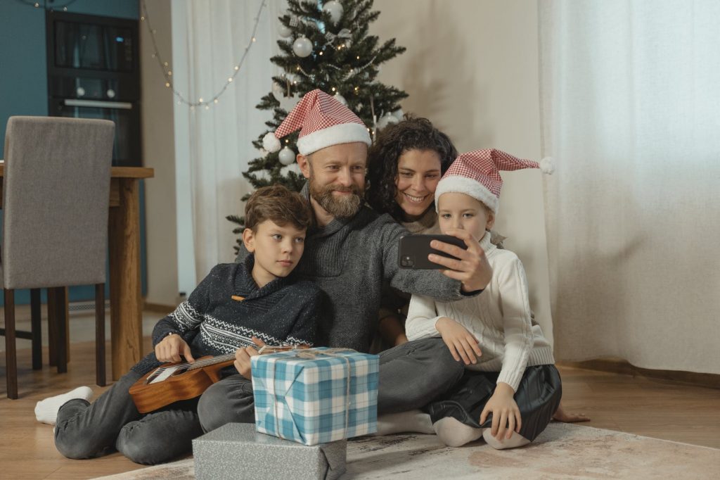 a family engaged in a vide call using a smartphone